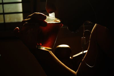 Midsection of man holding coffee cup