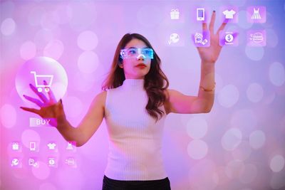 Beautiful woman wearing vr glasses and touching icons shopping the air,futuristic concept.