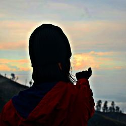 Silhouette of woman at sunset