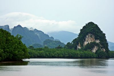 Idyllic shot of river and mountains against sky