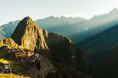 World heritage site machu picchu in peru at sunrise with sunrays on the mountain