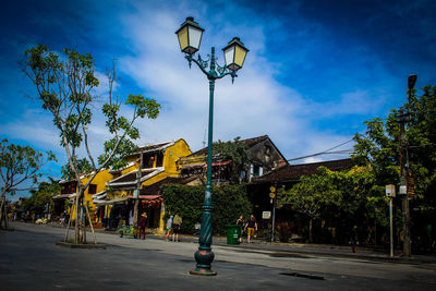 Low angle view of street and buildings against sky