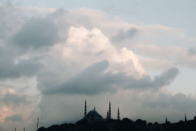 Low angle view of silhouette building against sky