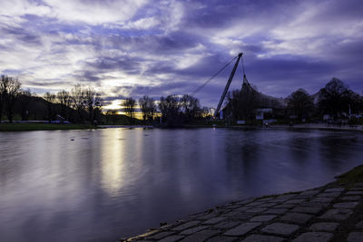 Scenic view of river against sky at dusk