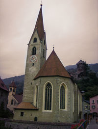 Low angle view of bell tower against sky