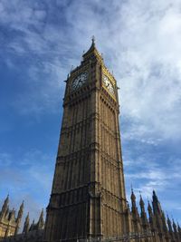 Low angle view of clock tower against sky