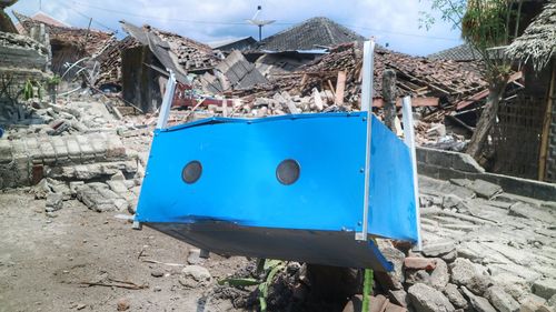 Blue container on abandoned building