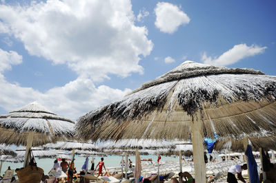 People on beach against sky