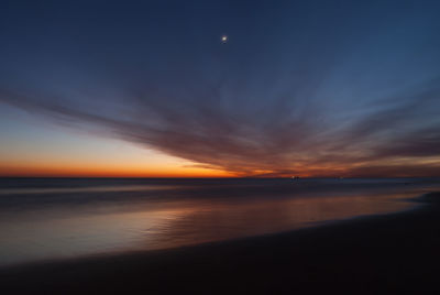 Scenic view of sea against sky at sunset