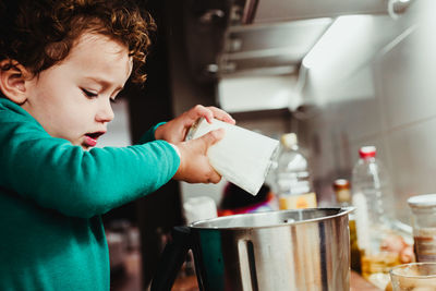 Boy holding ice cream at home