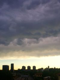Cityscape against cloudy sky