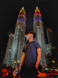 Malaysia 63rd independence day. low angle view of illuminated modern buildings in city at night