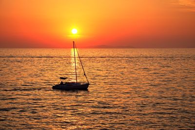 Scenic sunset on adriatic sea with boat sailing