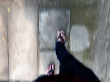 Low section of woman relaxing in water