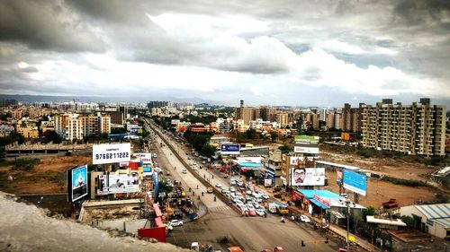 High angle view of city street against cloudy sky