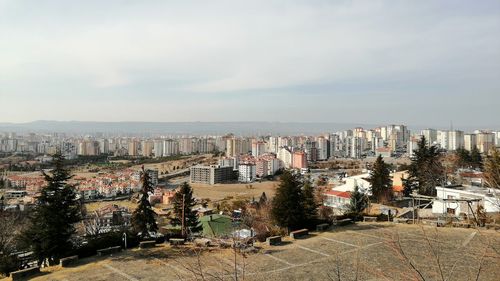 High angle view of buildings in city against sky