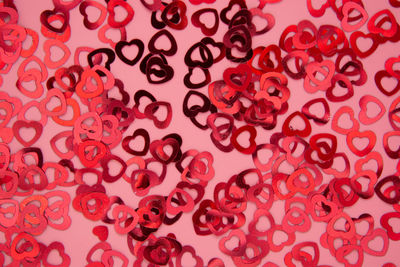 Close-up of heart shape over pink background