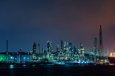 Illuminated cityscape against sky at night