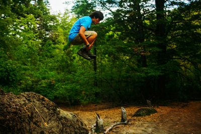 Man jumping in forest