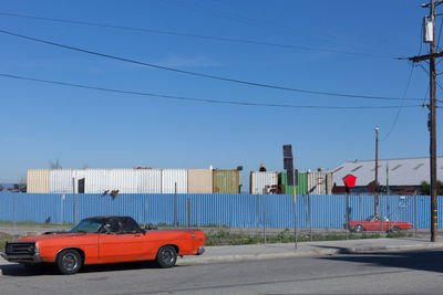 Cars on road against blue sky