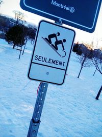 Road sign against blue sky