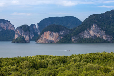 Scenic view of sea and mountains against sky