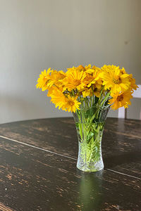 Close-up of yellow flower vase on table