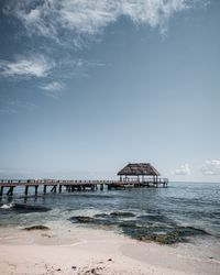 Scenic view of beach by sea against sky