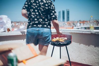 Woman cooking on barbecue grill