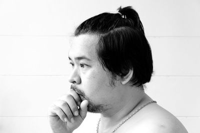 Close-up of sumo standing against wall