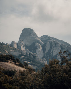 Scenic view of mountains against cloudy sky