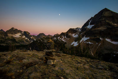 Scenic view of mountains against clear sky at dusk