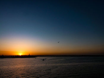 Scenic view of sea against clear sky during sunset