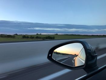 Reflection of car on side-view mirror