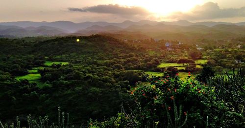Scenic view of mountains against sky at sunset