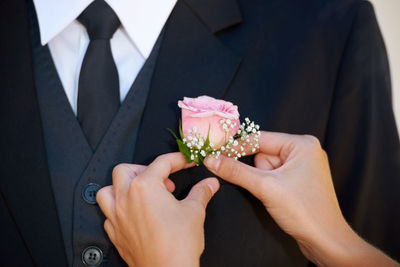 Midsection of bride holding bouquet