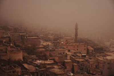 High angle view of cityscape against sky during foggy weather