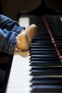 Low section of baby legs on piano