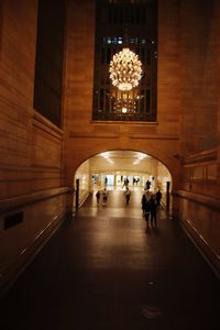 People walking in illuminated building
