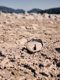 Close-up of wedding rings on sand