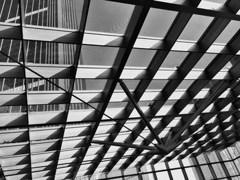 Low angle view of building seen through glass window