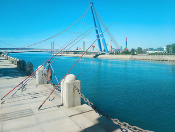 View of suspension bridge against blue sky