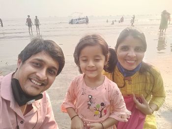 Portrait of happy friends on beach