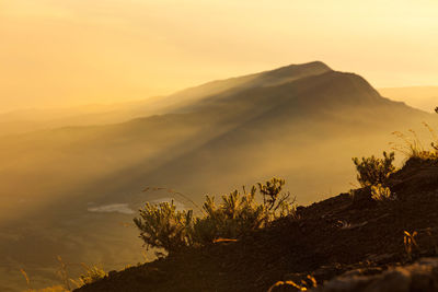 Scenic view of silhouette mountains against sky at sunset