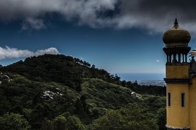 Scenic view of mountains and buildings against sky