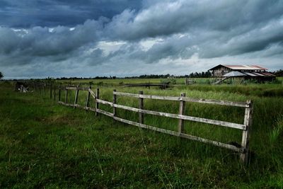 Scenic view of landscape against storm clouds