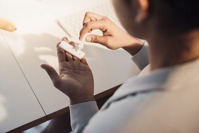 Businesswoman taking pregnancy test at desk