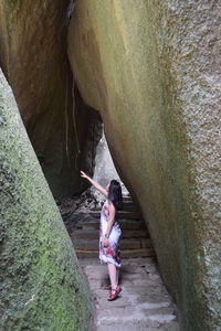 Full length of woman standing on rock