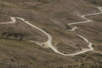 High angle view of tire tracks on road