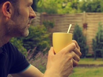 Side view of man preparing food outdoors